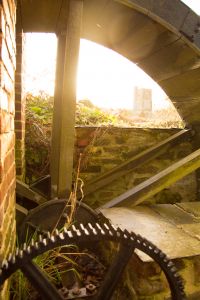 View of church through the waterwheel spokes