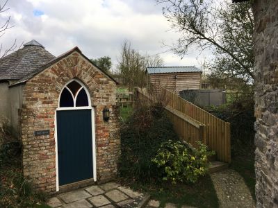 View from upstairs barn door towards Well House and upper garden area with hot tub