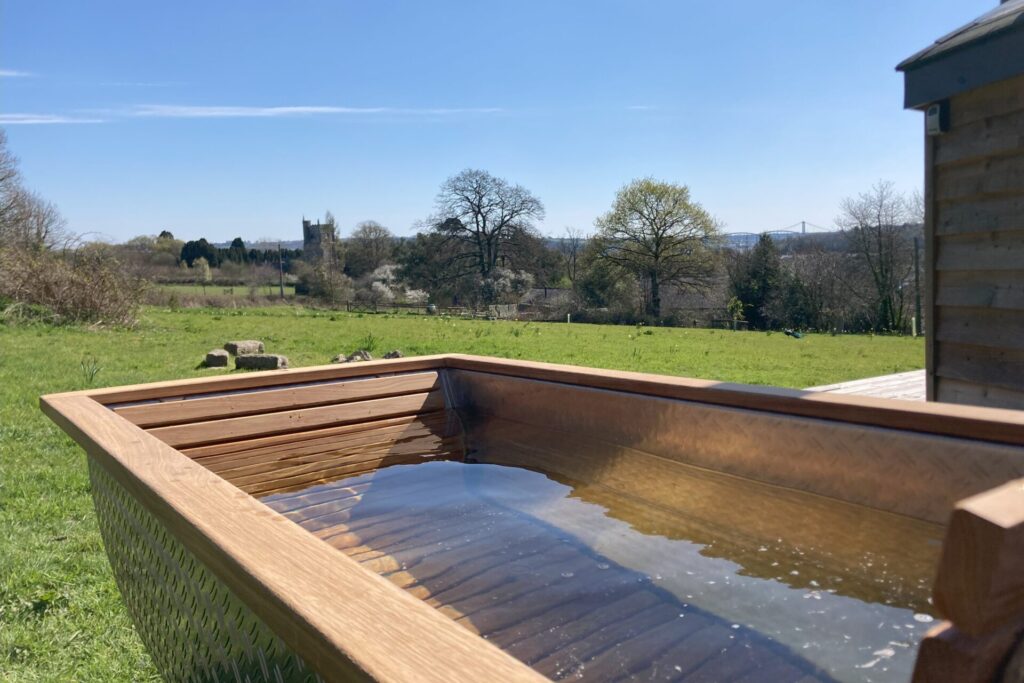 Glamping at Lower Marsh Farm, Cornwall - outside bath with a view